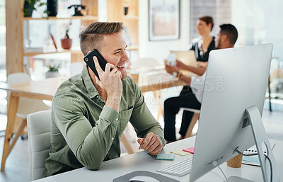 Buy stock photo Cropped shot of a handsome young businessman sitting and using his cellphone in the office
