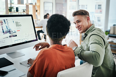 Buy stock photo Cropped shot of two young business colleagues having a discussion and working on a computer together in the office
