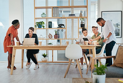 Buy stock photo Full length shot of a diverse group of business colleagues working on technology in the office