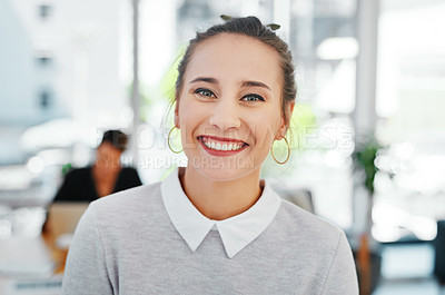 Buy stock photo Cropped portrait of an attractive young businesswoman standing alone in the office and smiling at the camera