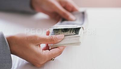 Buy stock photo Cropped shot of an unrecognizable businesswoman counting a stack of money in her office during the day