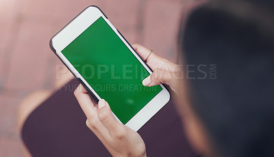 Buy stock photo Cropped shot of an unrecognizable businesswoman using a smartphone while sitting outdoors in the city