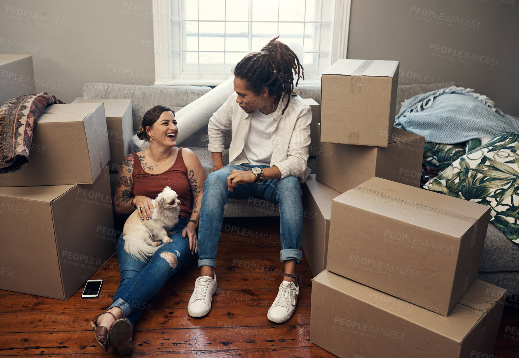 Buy stock photo Shot of a couple sitting with their dog while taking a break on moving day
