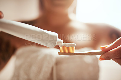 Buy stock photo Cropped shot of a woman brushing her teeth in the bathroom at home