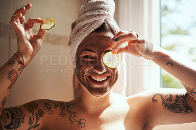 Buy stock photo Shot of a young woman giving herself a facial at home