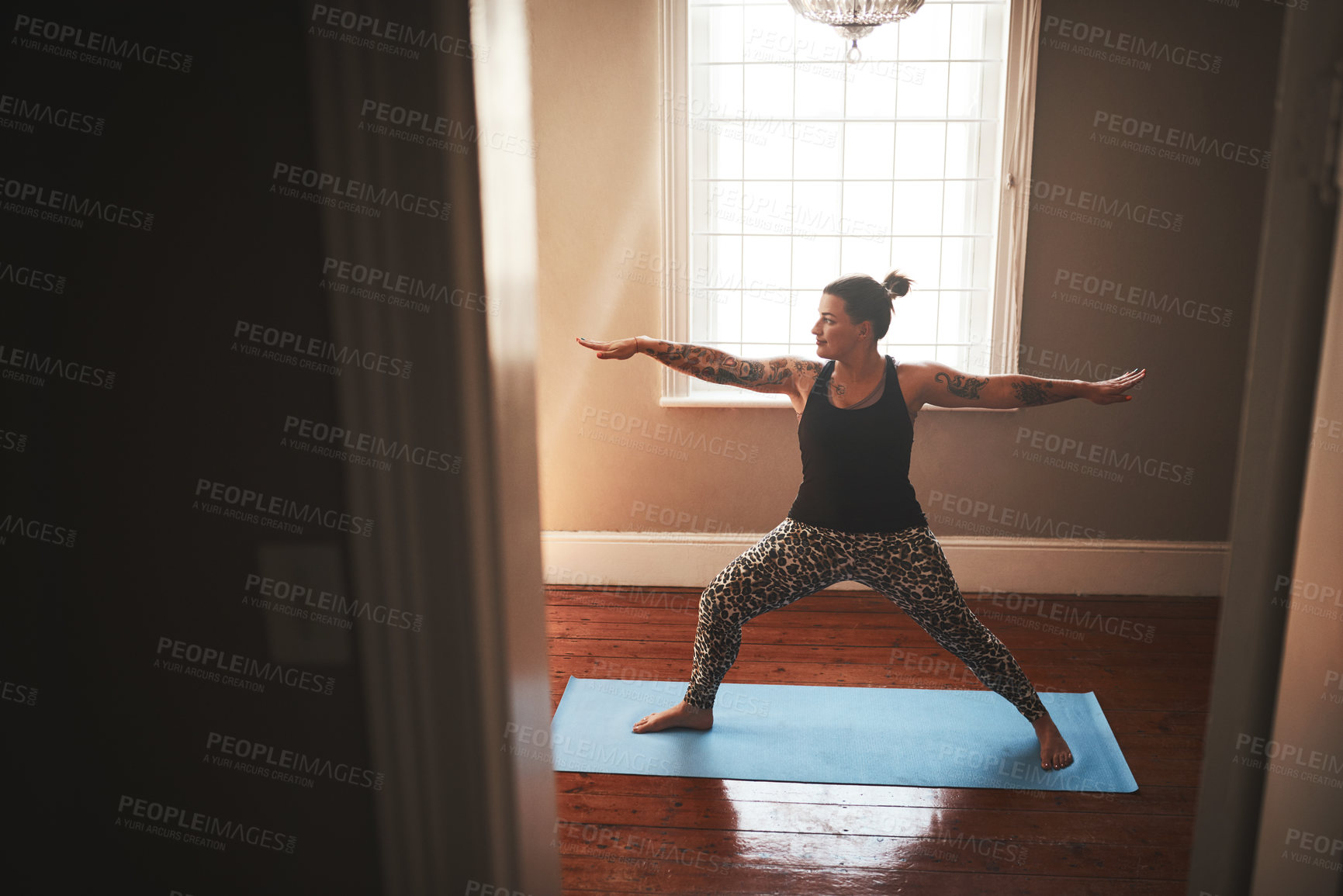 Buy stock photo Shot of a young woman practising yoga at home