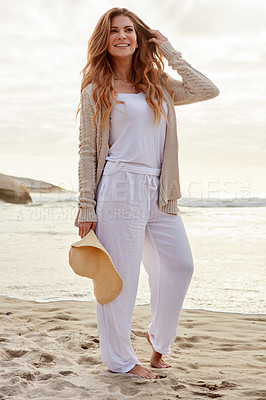 Buy stock photo Shot of a young woman spending some time at the beach