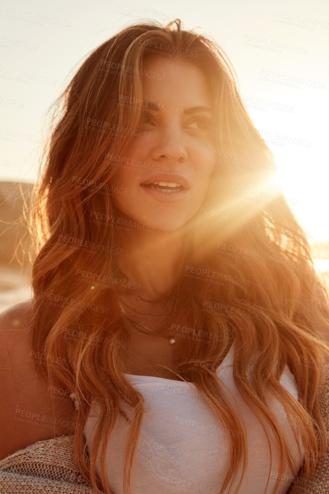 Buy stock photo Shot of a young woman spending some time at the beach