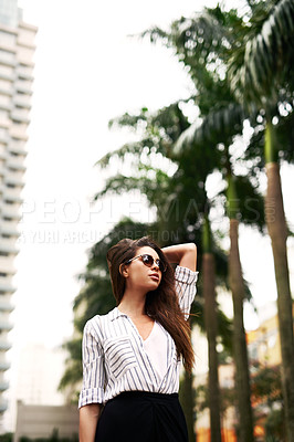 Buy stock photo Cropped shot of an attractive young woman standing outdoors during the day