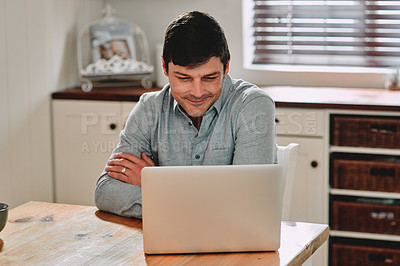 Buy stock photo Cropped shot of a man smiling while using his laptop