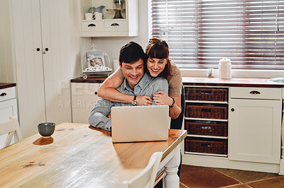 Buy stock photo Laptop, happy couple and hug in home for remote work, love or laughing together in kitchen. Computer, man and woman embrace freelancer on social media blog, website or reading funny meme on internet