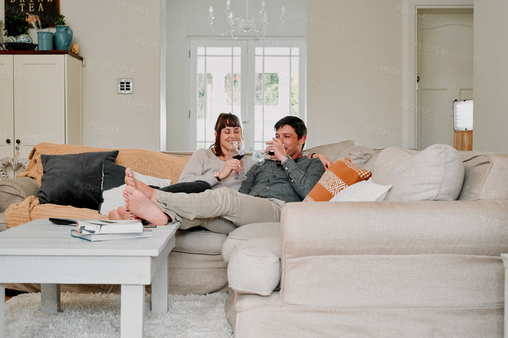 Buy stock photo Couple, happy or relax with wine glass in living room for romance, love and bonding together on weekend. Relationship, man and woman in home with alcohol beverage and smile for connection and comfort