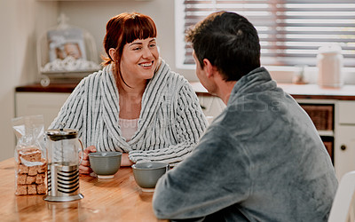 Buy stock photo Cropped shot of a couple having their morning coffee in their kitchen