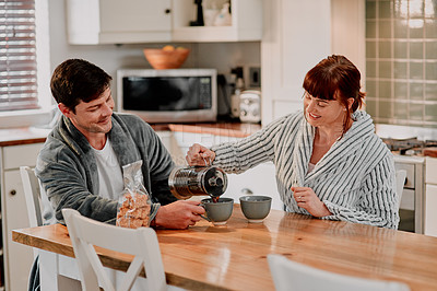 Buy stock photo Cropped shot of a couple having their morning coffee in their kitchen