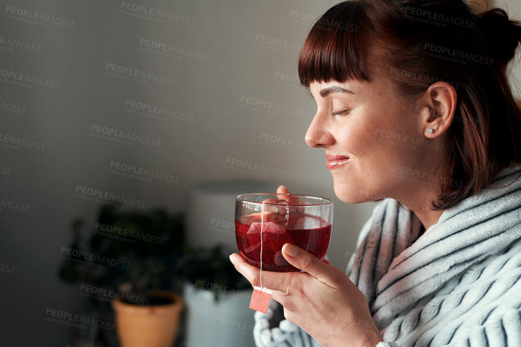 Buy stock photo Cropped shot of an attractive young woman drinking green tea in her bedroom at home