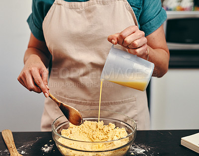 Buy stock photo Baking, bowl and hands of chef in kitchen with wooden spoon, pouring wet mix as ingredients for recipe. Batter, food and glass dish with person at counter of apartment diet, health or nutrition