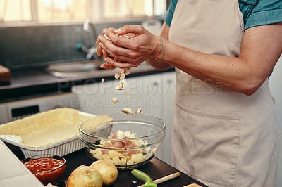 Buy stock photo Cropped shot of an unrecognizable woman cooking and preparing a meal inside her kitchen at home