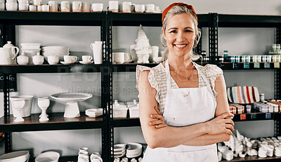 Buy stock photo Cropped portrait of an attractive mature woman standing with her arms folded in her pottery workshop