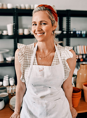 Buy stock photo Cropped portrait of an attractive mature woman standing alone in her pottery workshop during the day