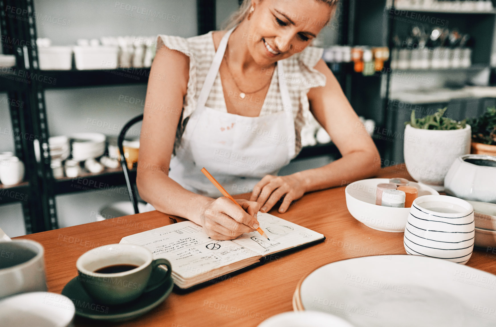 Buy stock photo Smile, woman potter and notebook in workshop for planning, creative ideas and craft page with pen. Small business, ceramic artist and book for pottery sketch, drawing and inspiration for startup