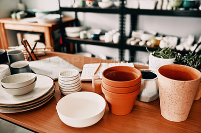 Buy stock photo High angle shot of a potter's collection and a notebook in her workshop during the day