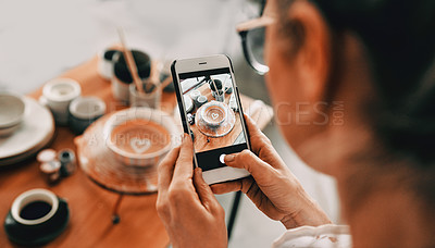 Buy stock photo Cropped shot of an unrecognizable woman standing and taking a picture of her pottery with her cellphone in her workshop