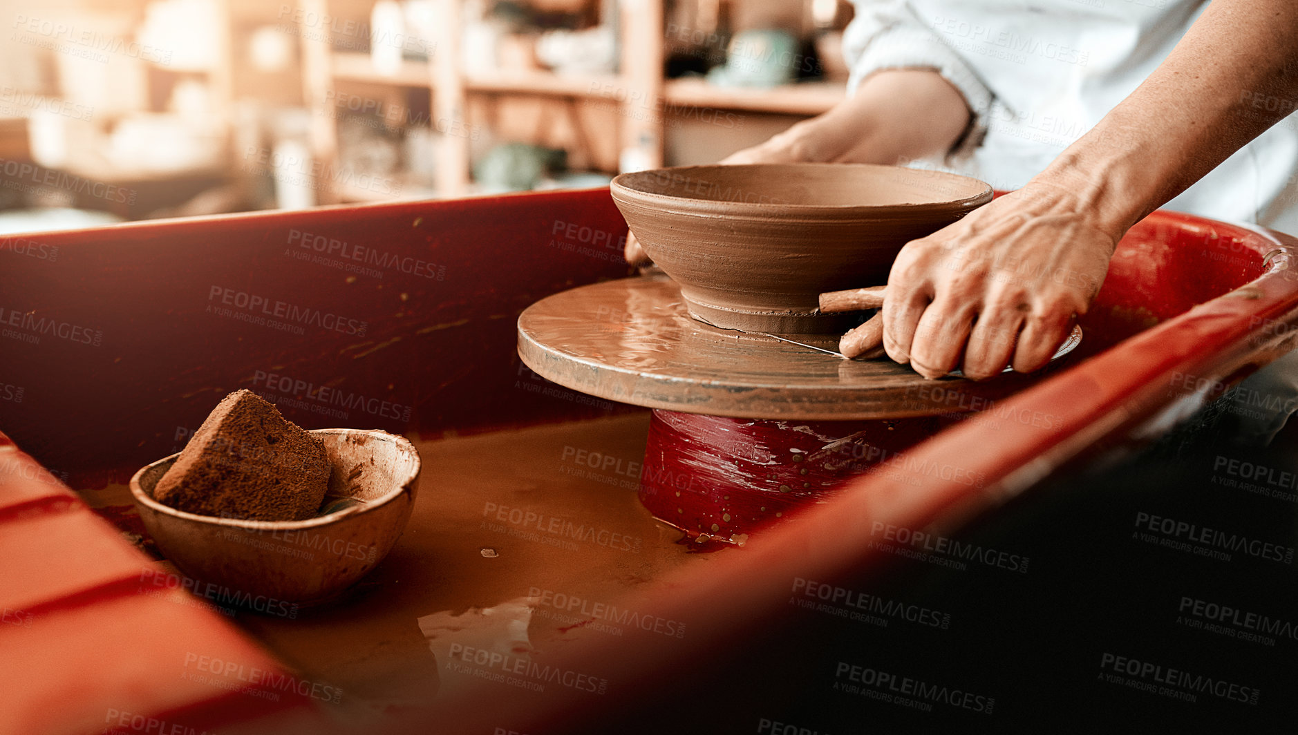 Buy stock photo Hands, clay and wheel for pottery in workshop with craft, tools and skills at small business. Person, artist and entrepreneur with material, creativity or manufacturing at startup factory for product