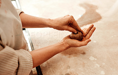 Buy stock photo Cropped shot of an unrecognizable artisan shaping a ball of clay with her hands
