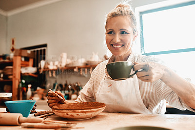 Buy stock photo Tea, smile and woman in pottery workshop, thinking and working in small business, art and morning. Coffee, creative and person with design for bowl, entrepreneurship and manufacturing in startup