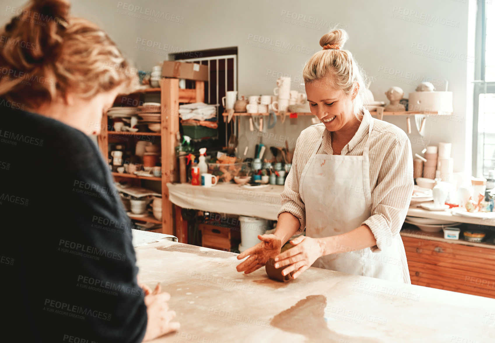 Buy stock photo Women, clay and pottery class in artist studio with design, mold and ceramic creation hobby at table. Teaching, workshop and handmade product with artisan, smile and craft with mud ball and learning