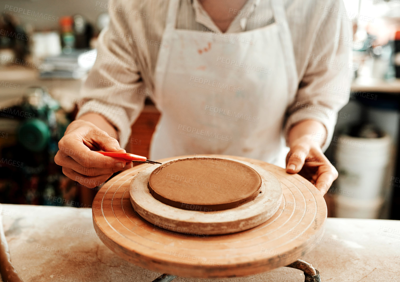 Buy stock photo Cropped shot of an unrecognizable artisan working in a pottery workshop