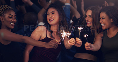 Buy stock photo Sparkler, party and night with women in club for music, celebration and nightlife concert. Festival, disco and happy hour with friends dancing in crowd at social event for energy, techno and dj show