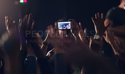 Buy stock photo Cropped shot of an unrecognizable young clubber taking photos while dancing in a nightclub