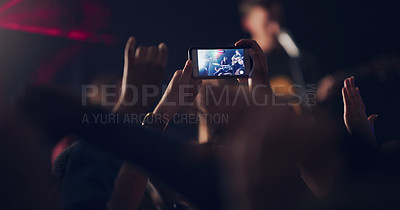 Buy stock photo Cropped shot of an unrecognizable young clubber taking photos while dancing in a nightclub