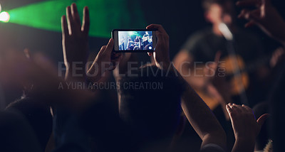 Buy stock photo Cropped shot of an unrecognizable young clubber taking photos while dancing in a nightclub