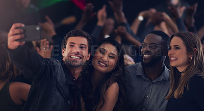 Buy stock photo Cropped shot of a group of young friends taking selfies while dancing together in a nightclub
