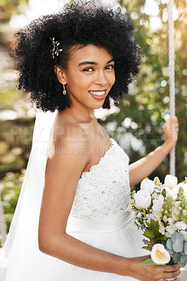 Buy stock photo Portrait of a happy and beautiful young bride holding a bouquet of flowers while posing outdoors on her wedding day