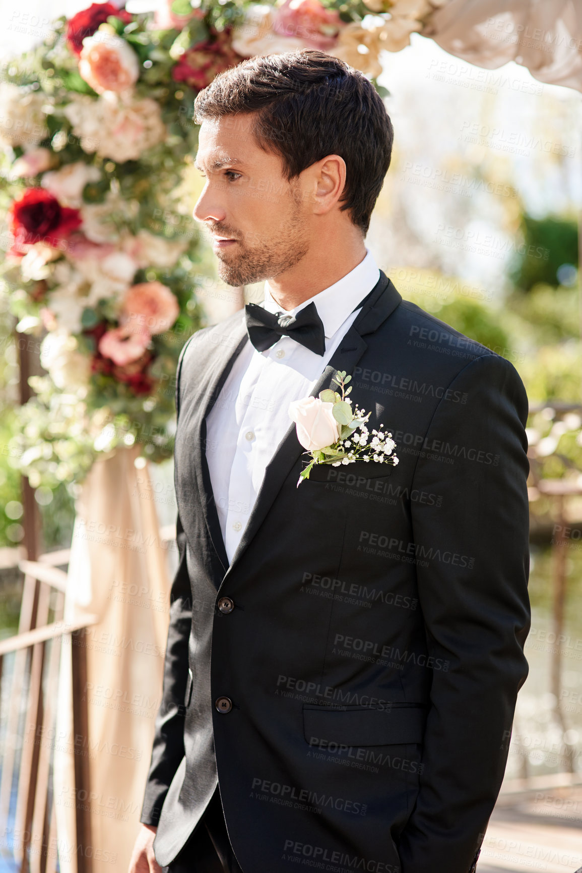 Buy stock photo Man, groom and wedding day at reception for marriage commitment with flower arch, ceremony or event. Male person, husband and boutonniere on suit at love celebration for milestone, backyard or bowtie