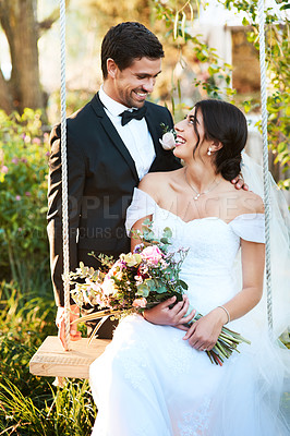 Buy stock photo Shot of a happy newlywed young couple posing together outdoors on their wedding day
