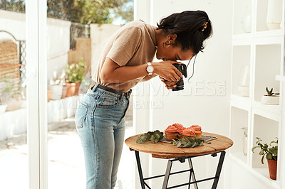 Buy stock photo Cropped shot of an attractive young businesswoman standing and using her camera to photograph cupcakes for her blog