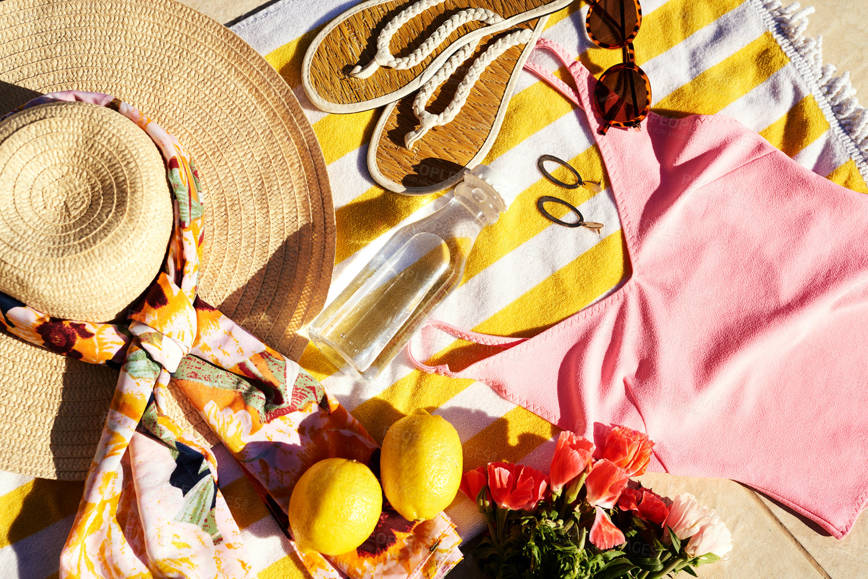 Buy stock photo Above, fruit and fashion at beach for summer, travel and water for hydration on towel. Swimwear, fresh citrus and flowers on floor for relax, sunny vacation and yellow for aesthetic on holiday