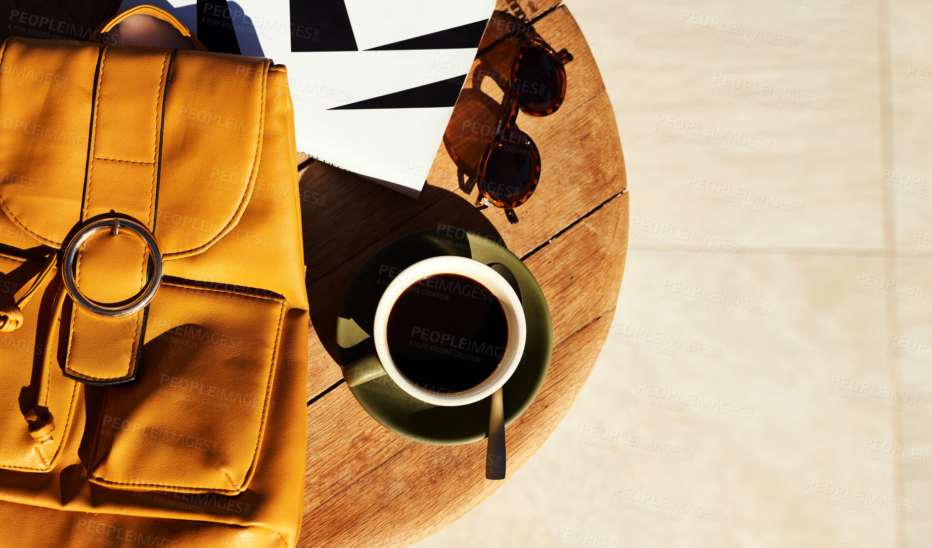 Buy stock photo Table, above and bag with coffee by book for travel guide, information and cafe beverage in morning. Backpack, glasses and warm drink at restaurant for vacation, agenda and itinerary of holiday