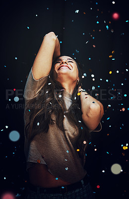 Buy stock photo Party, confetti and celebration with a woman in studio on a dark background for a new year event. Birthday, energy and smile with a happy young female on a black backdrop for a nightlife social