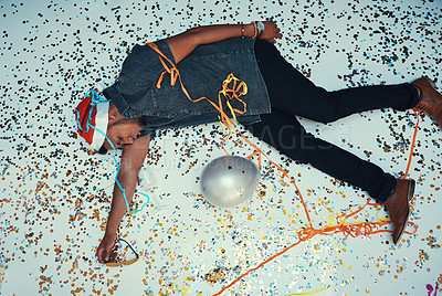 Buy stock photo Drunk, floor sleeping and man after christmas, party or holiday or new year with glitter confetti. Black man feeling tired and hangover from celebration, alcohol and social event with sleep after fun