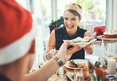 Buy stock photo Cropped shot of a group of cheerful young friends having Christmas lunch together at home