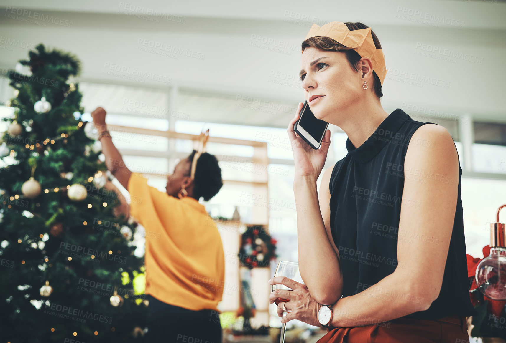 Buy stock photo Cropped shot of an attractive young woman looking concerned while taking a phonecall on Christmas day at home
