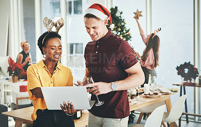Buy stock photo Cropped shot of a cheerful young couple smiling while using a laptop together on Christmas day at home