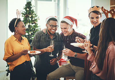 Buy stock photo Cropped shot of a group of cheerful young friends having cake and drinks together on Christmas day at home