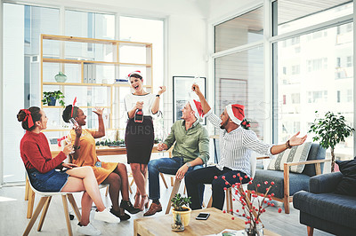 Buy stock photo Full length shot of a group of creative businesspeople drinking champagne and celebrating together at their office Christmas party