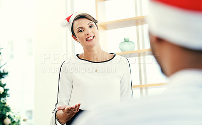 Buy stock photo Shot of an attractive young businesswoman speaking to her colleague at their office Christmas party